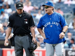 Jays manager John Gibbons, right, speaks with home plate umpire Scott Barry during the first game of a double header against the New York Yankees. (Photo by Jeff Zelevansky/Getty Images)