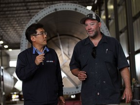 Seonghun Bang, left, vice president CS Wind Canada, speaks with supervisor Joel Swan in the internal mounting area of the wind turbine tower manufacturer August 21, 2013. (NICK BRANCACCIO/The Windsor Star)