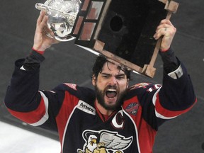 Grand Rapids captain Jeff Hoggan holds up the Calder Cup after his team defeated the Syracuse Crunch 5-2 in Game 6 of the Calder Cup in Syracuse, N.Y. (AP Photo/The Syracuse Newspapers, Mike Greenlar)