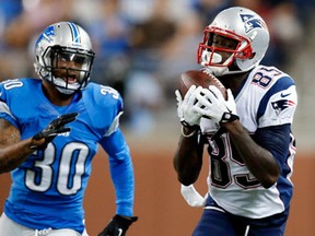 New England receiver Kenbrell Thompkins, right, catches a pass for a 37-yard gain against Detroit defensive back Darius Slay at Ford Field Thursday. (AP Photo/Rick Osentoski)