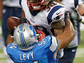 Detroit linebacker DeAndre Levy, left, forces a fumble during a run by Brandon Bolden of the New England Patriots at Ford Field Thursday. (Photo by Gregory Shamus/Getty Images)