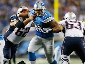 Detroit's Ndamukong Suh, centre, tries to get through the blocks of Ryan Wendell #62 and Dan Connolly, left, of the New England Patriots at Ford Field Thursday. (Photo by Gregory Shamus/Getty Images)