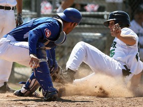 Windsor's Cam Goddard, right, is tagged out at home by Fredericton catcher Jody Peterson during the second day of the Canadian Senior Baseball Championships at Cullen Field in Windsor Friday.       (TYLER BROWNBRIDGE/The Windsor Star)