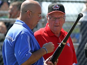 Tournament chairperson Bernie Soulliere, right, talks to umpire supervisor Ron Shewchuk after Bryan Dufour was found to be using an illegal bat against the Fredericton Royals during the second day of the Canadian Senior Baseball Championships at Cullen Field Friday,  (TYLER BROWNBRIDGE/The Windsor Star)