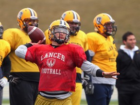 Lancers quarterback Austin Kennedy, centre, throws a pass during spring practice. (NICK BRANCACCIO/The Windsor Star)