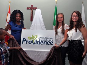 Students Roni Sangwa, left, Tezzy Ngongo, Abigail Rocheleau and student trustee Christine St-Pierre, right, unveil the new name and logo for the former Conseil Scolaire de district des ecoles cahtoliques du Sud-Ouest Monday August 26, 2013.  The new name, Conseil Scolaire Catholique Providence, was announced at Place Concorde by director of education Joseph Picard. (NICK BRANCACCIO/The Windsor Star)