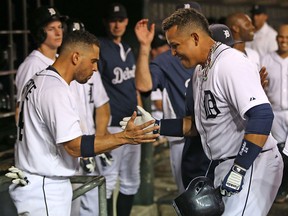 Detroit's Miguel Cabrera, right, celebrates with teammate Omar Infante after hitting a two-run homer in the fifth inning against the Oakland Athletics at Comerica Park Monday. (Photo by Leon Halip/Getty Images)