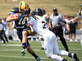 University of Windsor wide receiver Evan Pszczonak, left, tries to break free from Waterloo's Harrison Mair at Alumni Field, Sunday. (DAX MELMER/The Windsor Star)