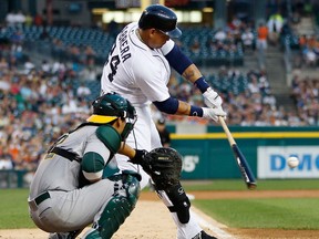 Detroit's Miguel Cabrera, right, hits a third-inning single in front of Kurt Suzuki of the Oakland Athletics at Comerica Park Wednesday. (Photo by Gregory Shamus/Getty Images)