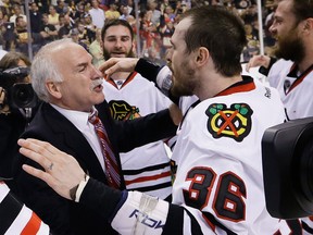 Chicago Blackhawks head coach Joel Quenneville, left, and forward Dave Bolland celebrate the Stanley Cup championship after the Blackhawks beat the Boston Bruins 3-2in Game 6 of the Stanley Cup Finals. (AP Photo/Elise Amendola)