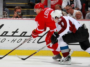 Detroit's Nicklas Lidstrom, left, is checked by Colorado's Matt Duchene at Joe Louis Arena. (Photo by Gregory Shamus/Getty Images)