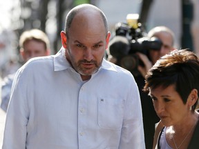Former NFL player Kevin Turner accompanied by Lisa McHale, the widow of former NFL player Tom McHale, walk to the U.S. Courthouse April 9, 2013. (AP Photo/Matt Rourke, File)
