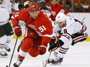 Detroit's Valtteri Filppula, left, is checked by Chicago's Jonathan Toews at Joe Louis Arena. (Photo by Gregory Shamus/Getty Images)