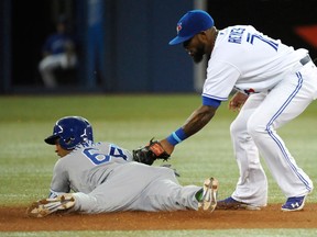 Toronto's Jose Reyes, right, is too late on the tag against Kansas City's Emilio Bonifacio during the first inning in Toronto Friday. (THE CANADIAN PRESS/Jon Blacker)