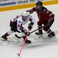 Windsor's Jordan Maletta, left, makes a move on Jonathan Jasper of the Kitchener Rangers at the WFCU Centre. (NICK BRANCACCIO/The Windsor Star)