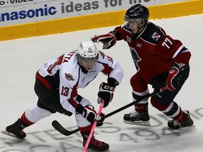 Windsor's Jordan Maletta, left, makes a move on Jonathan Jasper of the Kitchener Rangers at the WFCU Centre. (NICK BRANCACCIO/The Windsor Star)