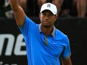 Tiger Woods reacts after making a par put on the 18th green to finish his round with a 61 during the second round of the World Golf Championships-Bridgestone Invitational at Firestone Country Club in Akron, Ohio.  (Photo by Sam Greenwood/Getty Images)