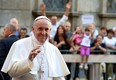 In this file photo, Pope Francis salutes as he arrives at the Chiesa Del Gesu' in Rome on July 31, 2013. The Pontiff has charmed the masses with his informal style, simplicity and sense of humour — and a handful of strangers have gotten the treatment up close, receiving papal phone calls out of the blue after writing him or suffering some personal tragedy. (Alberto Pizzoli/AFP/Getty Images)