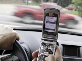 A cellphone is used in a car. (Associated Press files)