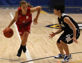 Olivia Starling, left, from Windsor-Essex, drives past South Korea's Kim Min Jung, during the girls basketball gold-medal game in the International Children's Games at the St. Denis Centre, Sunday, August 18, 2013.  (DAX MELMER/The Windsor Star)