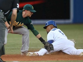 Toronto's Emilio Bonifacio, right, steals second base in the second inning against Oakland's Jed Lowrie on August 9, 2013 at Rogers Centre in Toronto, Ontario, Canada. (Photo by Tom Szczerbowski/Getty Images)