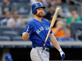 Blue Jays pinch-hitter Adam Lind flips his bat after striking out against the New York Yankees at Yankee Stadium, Thursday, Aug. 22, 2013, in New York. (AP Photo/Kathy Willens)