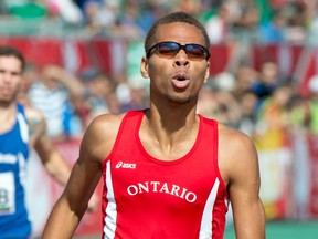 Windsor's Brandon McBride reacts as he crosses the finish line to win the gold medal in the men's 400-metre race at the Canada Summer Games Thursday, August 15, 2013 in Sherbrooke, Quebec. THE CANADIAN PRESS/Paul Chiasson