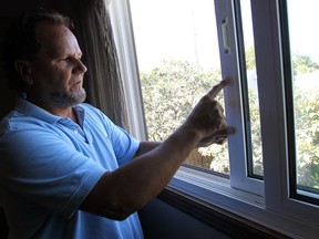 Ron Fryer looks over a window after thieves broke into his house last weekend in Amherstburg on Friday, August 23, 2013.          (TYLER BROWNBRIDGE/The Windsor Star)