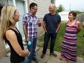 Sarah Baeumler, left, and her husband Bryan Baumier, third from left, from HGTVs Leave it to Bryan, visit the home of Michael and Cynthia Jamieson in Windsor on Wednesday, August 7, 2013. The couple stopped in to assess mould remediation work that is needed.             (TYLER BROWNBRIDGE/The Windsor Star)