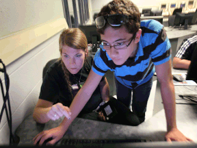 In this file poto, Jenna Spence, a liaison with Skills Canada, works with Jonathan D'Antonio during a skilled trades camp at St. Clair College on Aug. 15, 2013. (DAN JANISSE/The Windsor Star)