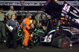 Emergency personnel prepare to load NASCAR driver Tony Stewart into an ambulance after a four-car wreck at Southern Iowa Speedway in Oskaloosa, Iowa. (AP Photo/The Des Moines Register, Mary Willie)