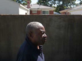 Lorenzer West, 84, stands next to a 6-foot high concrete wall in the backyard of his home on 19900 block of Mendota St. in the 8 Mile-Wyoming neighbourhood of northern Detroit, Thursday, August 15, 2013.  The wall was constructed by a developer in 1940 in order to secure a government loan to build a white-only neighbourhood, separated by the wall from the existing black one.  (DAX MELMER/The Windsor Star)