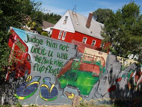 A six-foot high wall covered in graffiti and civil rights inspired art is pictured adjoining the Alfonso Wells Memorial Playground in the 8 Mile-Wyoming neighbourhood of northern Detroit, Thursday, August 15, 2013.  The wall was constructed by a developer in 1940 in order to secure a government loan to build a white-only neighbourhood that would be separated by the wall from the existing black one.  (DAX MELMER/The Windsor Star)