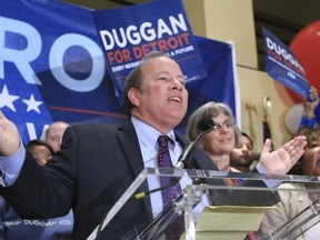 Detroit mayoral write-in candidate Mike Duggan takes the stage to talk with excited supporters after favorable primary election results during a party at the Atheneum Hotel in Detroit on Tuesday Aug. 6, 2013. (AP Photo/Detroit Free Press, Ryan Garza)
