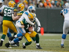 Detroit's Willie Young, left, sacks Packers QB Matt Flynn at Lambeau Field in Green Bay, Wisconsin. (Photo by Scott Boehm/Getty Images)