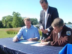 ERCA general manager Richard Wyma, from left, ERCA chairman Joe Bachetti and Dr. John Hartig, refuge manager for Detroit River International Wildlife Refuge sign an agreement Wednsday, part of which created a Canadian Registry of Lands similar to the U.S. Detroit River’s International Wildlife Refuge. ERCA committed 3,800 acres of conservation lands in the Detroit River and Lake Erie watersheds.
(Julie Kotsis/The Windsor Star)