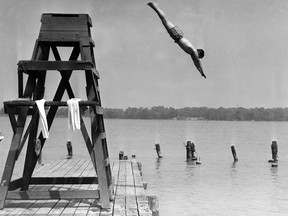 Hundreds of Windsor children are being forced to swim in the polluted Detroit River because of overcrowded conditions at city pools. J. Ross Paisley, city recreation director, told the recreation committee Monday night that there just wasn't room enough for all the children. Gerald Godfrey, 15, of 845 Albert Rd., is shown diving into the river at the East Windsor Bathing Beach on the morning of June 12, 1956 while city pools were closed. (FILES/The Windsor Star)