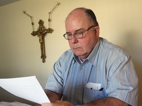Rev. Mike Graham studies a homily at his parish of Our Lady of the Atonement Church in this a 2008 file photo. (Nick Brancaccio / The Windsor Star)