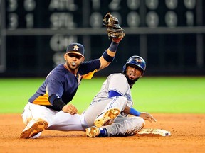 Toronto's Jose Reyes, right, is tagged out at second base in the eighth inning by Houston's Jonathan Villar at Minute Maid Park on August 25, 2013 in Houston, Texas.  (Photo by Stacy Revere/Getty Images)