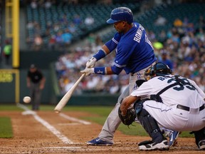 Toronto's Emilio Bonifacio, left, hits a two-run double against the Mariners at Safeco Field on August 6, 2013 in Seattle, Wash.  (Otto Greule Jr/Getty Images)