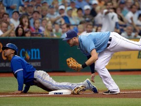 Toronto's Anthony Gose, left, safely advances to third base on a fly-out by Jose Bautista as Tampa Bay third baseman Evan Longoria, right, is late with the tag in St. Petersburg, Fla., Sunday, Aug. 18, 2013. (AP Photo/Phelan M. Ebenhack)