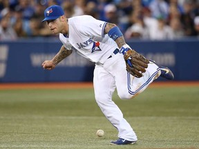 Blue Jays third baseman Brett Lawrie misses a ground ball in the fourth inning against the Boston Red Sox on August 13, 2013 at Rogers Centre in Toronto, Ontario, Canada. (Photo by Tom Szczerbowski/Getty Images)