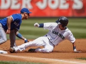 Seattle's Nick Franklin, right, slides into third with an RBI triple against Toronto's Brett Lawrie at Safeco Field August 7, 2013 in Seattle. (Otto Greule Jr/Getty Images)