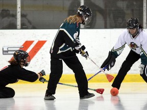 Playing defence, Kelly Steele, centre, keeps the ball from Windsor Roadrunner player, left, for Windsor Devils goaltender to make a save in broomball game at WFCU Community Rinks  recently. (NICK BRANCACCIO / The Windsor Star)