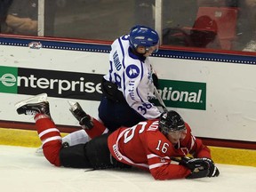 Spitfires forward Kerby Rychel, bottom, collides with Finland's Juuso Vainio during their Hockey Junior Evaluation Camp exhibition game at the Lake Placid Olympic Center on August 7, 2013 in Lake Placid, N.Y.  (Bruce Bennett/Getty Images)
