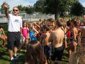 John McKibbon gives directions to a group of youngsters during the Kids of Steel Triathlon Camp at Lacasse Park recently. (DAN JANISSE / The Windsor Star)