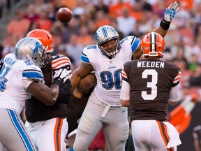 Lions defensive tackle Ndamukong Suh, right, tries to block a pass by Browns quarterback Brandon Weeden during NFL pre-season action at FirstEnergy Stadium on August 15, 2013 in Cleveland, Ohio. (Photo by Jason Miller/Getty Images)