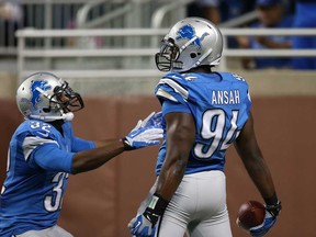 Detroit rookie Ezekiel Ansah right, celebrates a first quarter TD with teammate Don Carey after intercepting the pass against the New York Jets at Ford Field on August 9, 2013 in Detroit.  (Leon Halip/Getty Images)