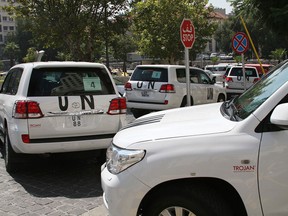 A U.N. team, that is scheduled to investigate an alleged chemical attack that killed hundreds last week in a Damascus suburb, leaves their hotel in a convoy, in Damascus, Syria, Monday, Aug. 26, 2013. (AP Photo)