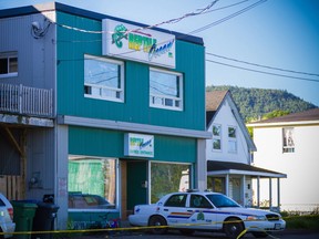 An RCMP cruiser sits outside the Reptile Ocean exotic pet store in Campbellton, N.B., on Tuesday, August 6, 2013. The owner of a New Brunswick exotic pet store that housed an African rock python that escaped and strangled two young boys says he is in shock. THE CANADIAN PRESS/John LeBlanc
